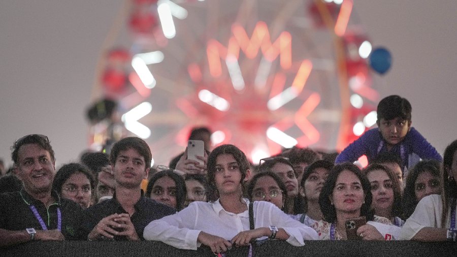 Spectators watch singer AP Dhillon's performance during Lollapalooza India music festival at Mahalaxmi Race Course in Mumbai, Saturday, Jan. 28, 2023.