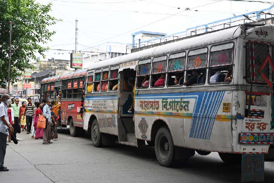 Buses stop to pick up passengers in the middle of the road in Gariahat, instead of at the designated bus stop, on Thursday