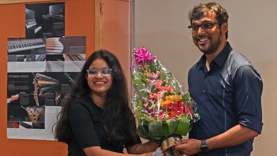 Kaushik Das receives a bouquet from (left) Adrija Das