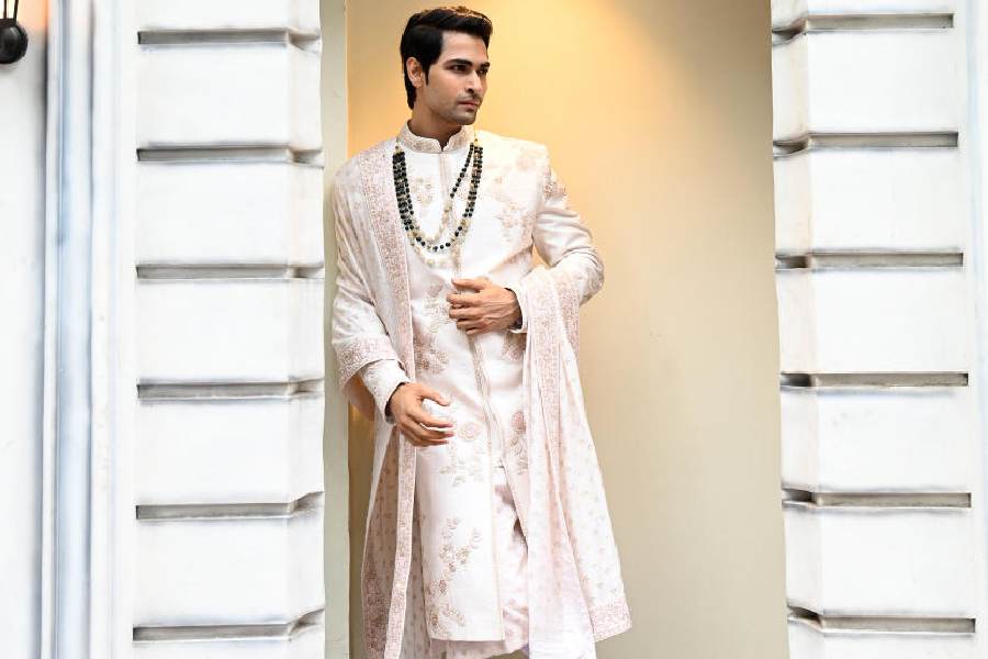 This pale pink hand-embroidered monotone sherwani in silk is classic groom wear. #GroomsOfYajy