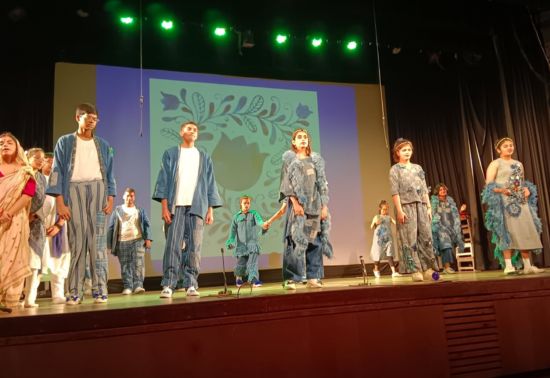 Akshar Students' Fashion Show modelling clothes designed by Mr. Bappaditya Biswas while the choir sings 'Song Sung Blue'