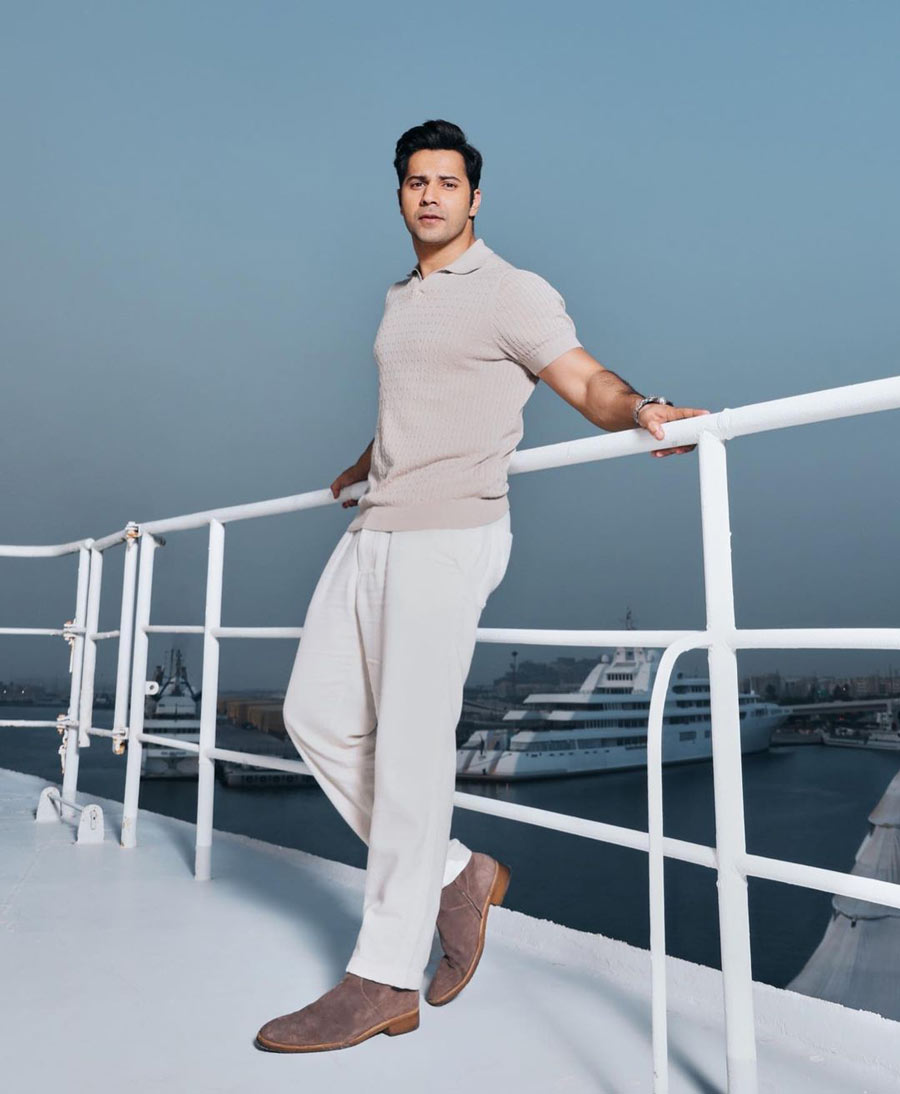 Varun looked dapper in a beige t-shirt and white trousers with brown corduroy shoes. 