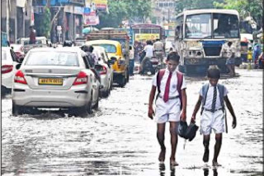 Commuters on a waterlogged MG Road on Wednesday afternoon