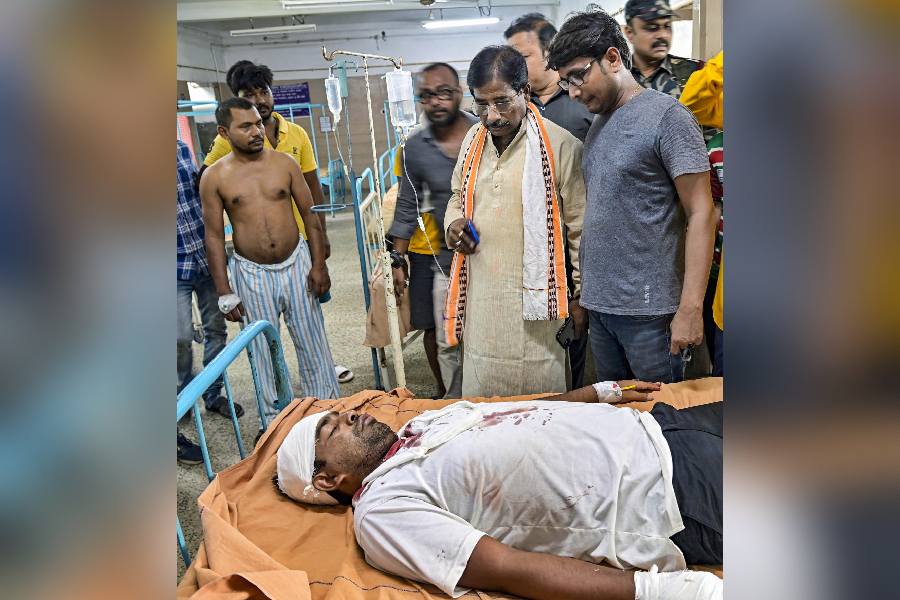 Nadia: BJP MP Jagannath Sarkar meets with party candidate Gouranga Biswas at Santipur Hospital after an alleged attack on him by Trinamool Congress (TMC) supporters, in Nadia district, Wednesday