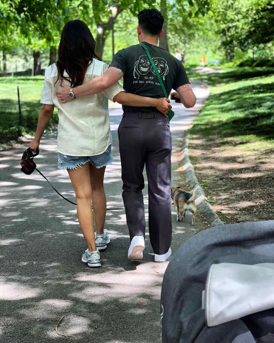 Priyanka and Nick take Diana for a walk on a bright sunny day.