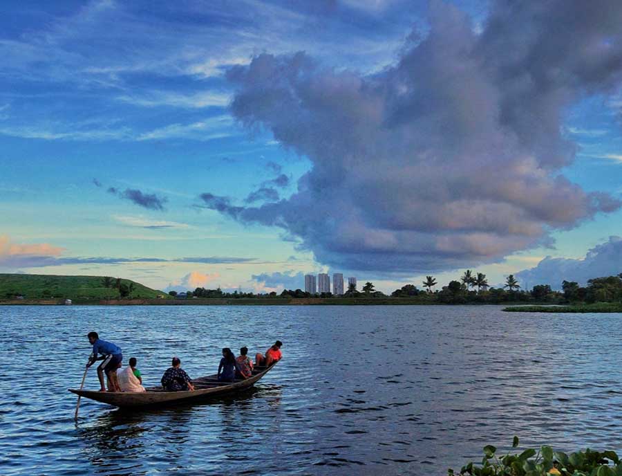 People take a boat ride on the east Kolkata wetlands 