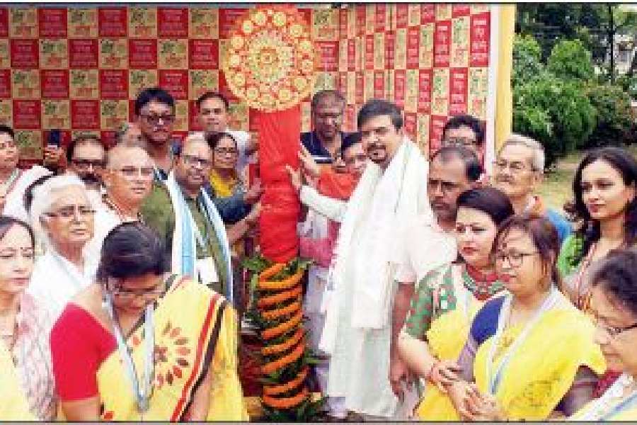 Minister and MLA Sujit Bose (in white) holds the khuti at GD Block’s puja