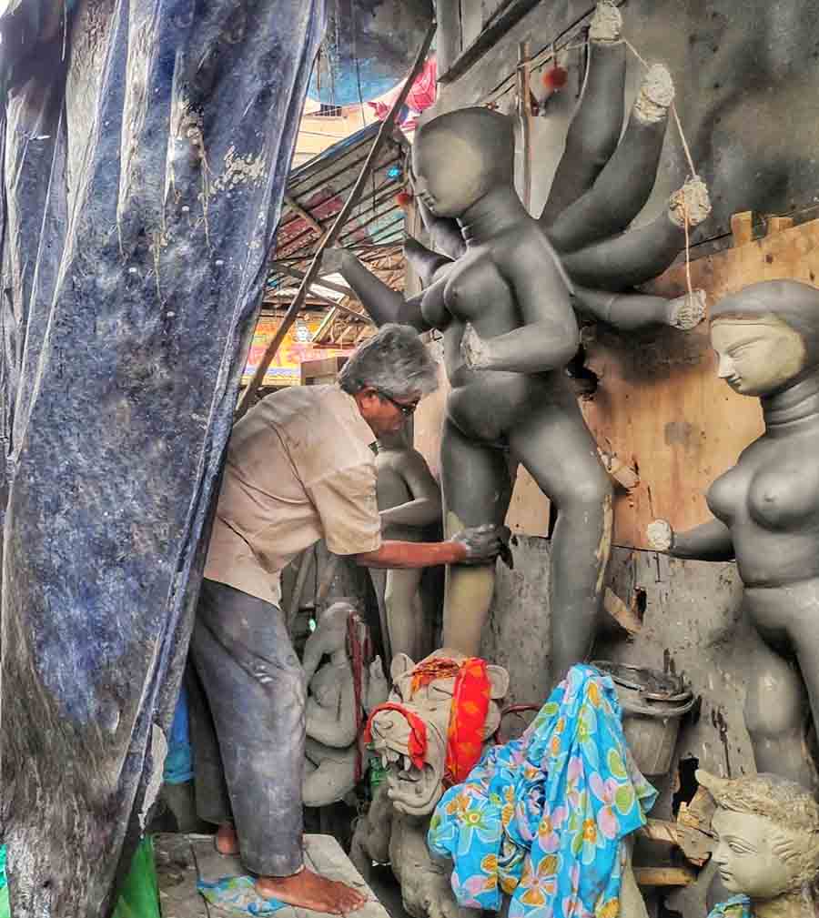 A glimpse from the busy alleys of Kumartuli where artisans continue their work amid the vagaries of monsoon  