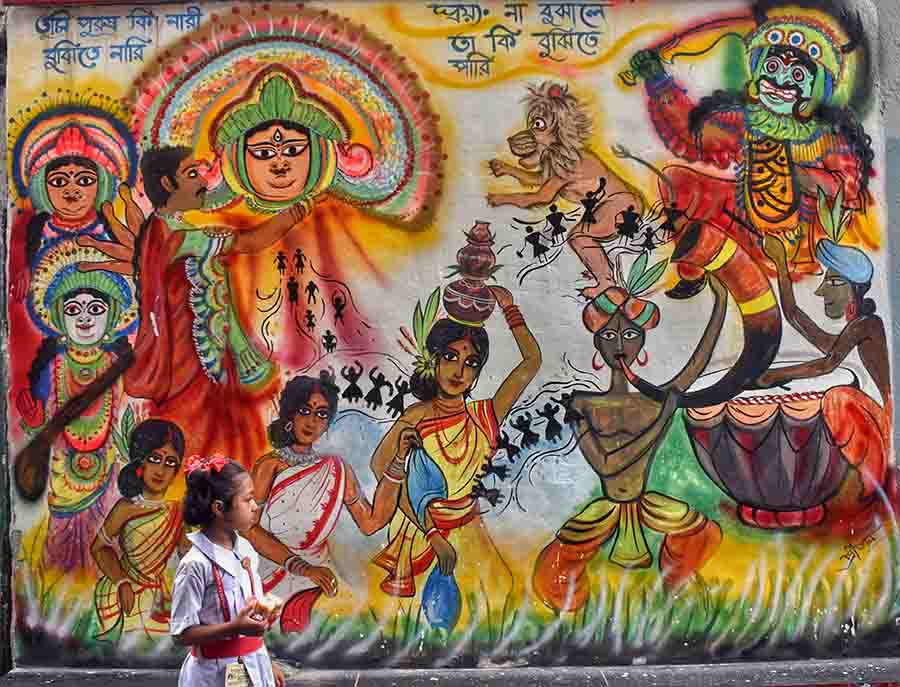 A student looks at a graffiti of Durga Puja in north Kolkata on Wednesday   