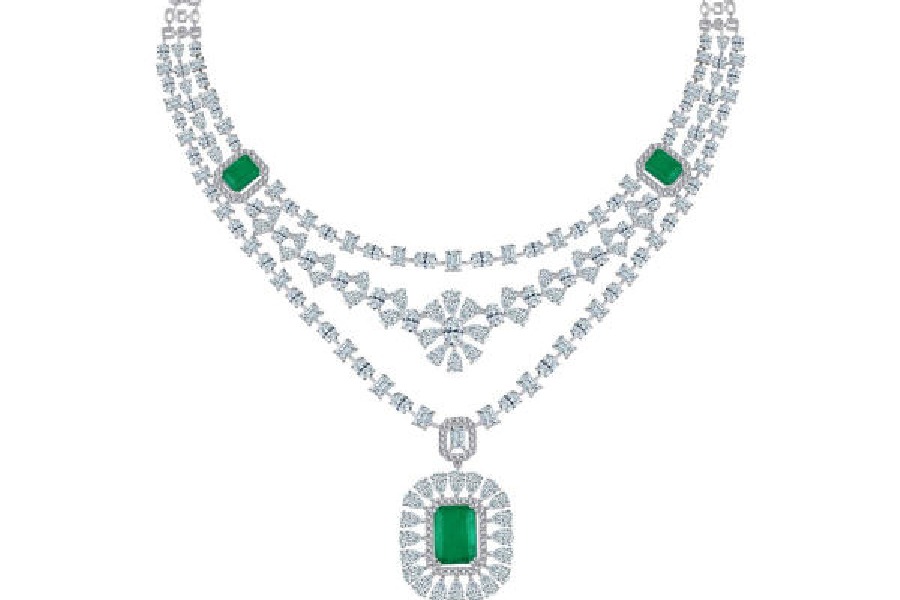 A stunning necklace, adorned with labgrown diamonds and emeralds, exuding timeless elegance, crafted in 18K gold