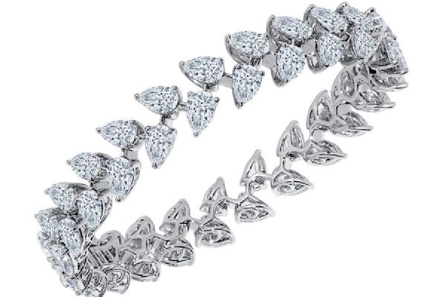 A radiant bangle, set with Marquis-shaped lab-grown diamonds, made in 18K gold.