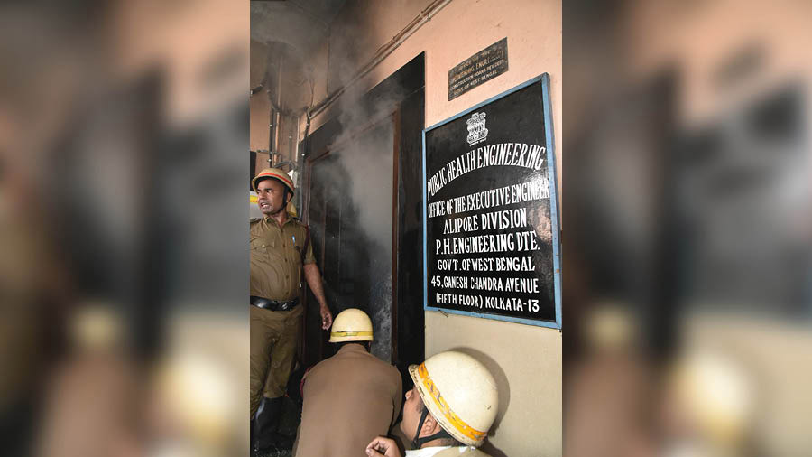 Thick plumes of smoke billow out of the public health engineering office on Ganesh Chandra Avenue on Thursday morning even as firemen try to gain access into it to douse the flames. 