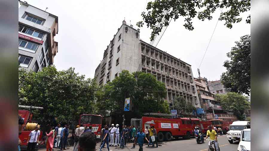 Fire tenders and fire services personnel in front of the building at 45 Ganesh Chandra Avenue, which houses offices of the transport and the animal resources departments.