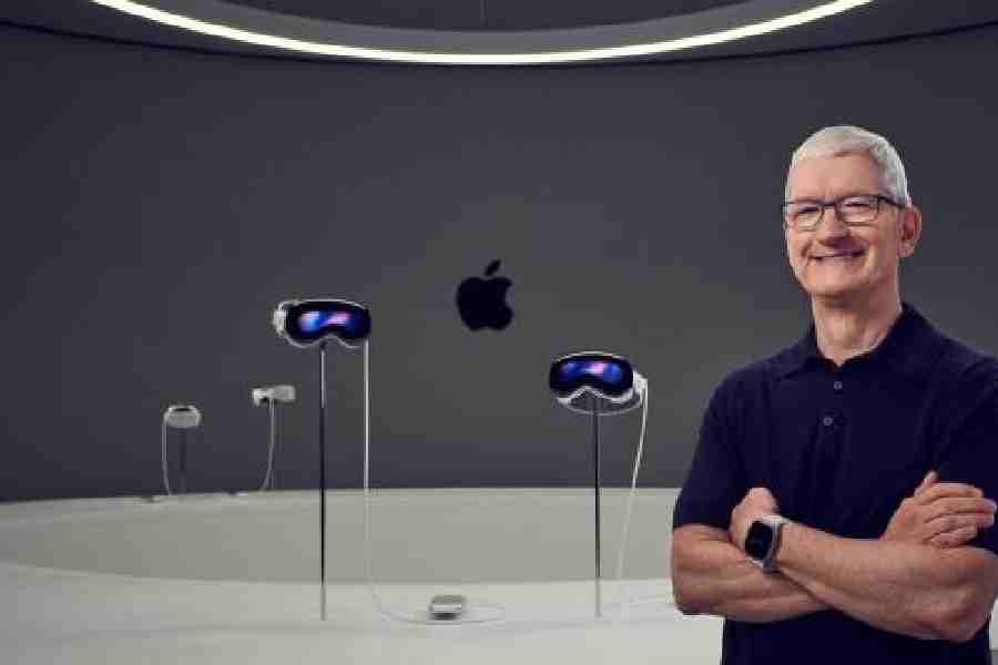 Apple CEO Tim Cook with members of the media next to Apple’s new Vision Pro virtual reality headset, during Apple’s Worldwide Developers Conference (WWDC) at the Apple Park campus in Cupertino. 