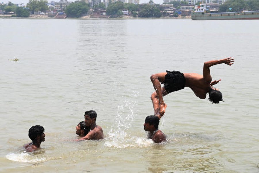 Boys have fun in the Hooghly at Babughat on Sunday afternoon, around which time the temperature in Kolkata soared to 37 degrees Celsius 
