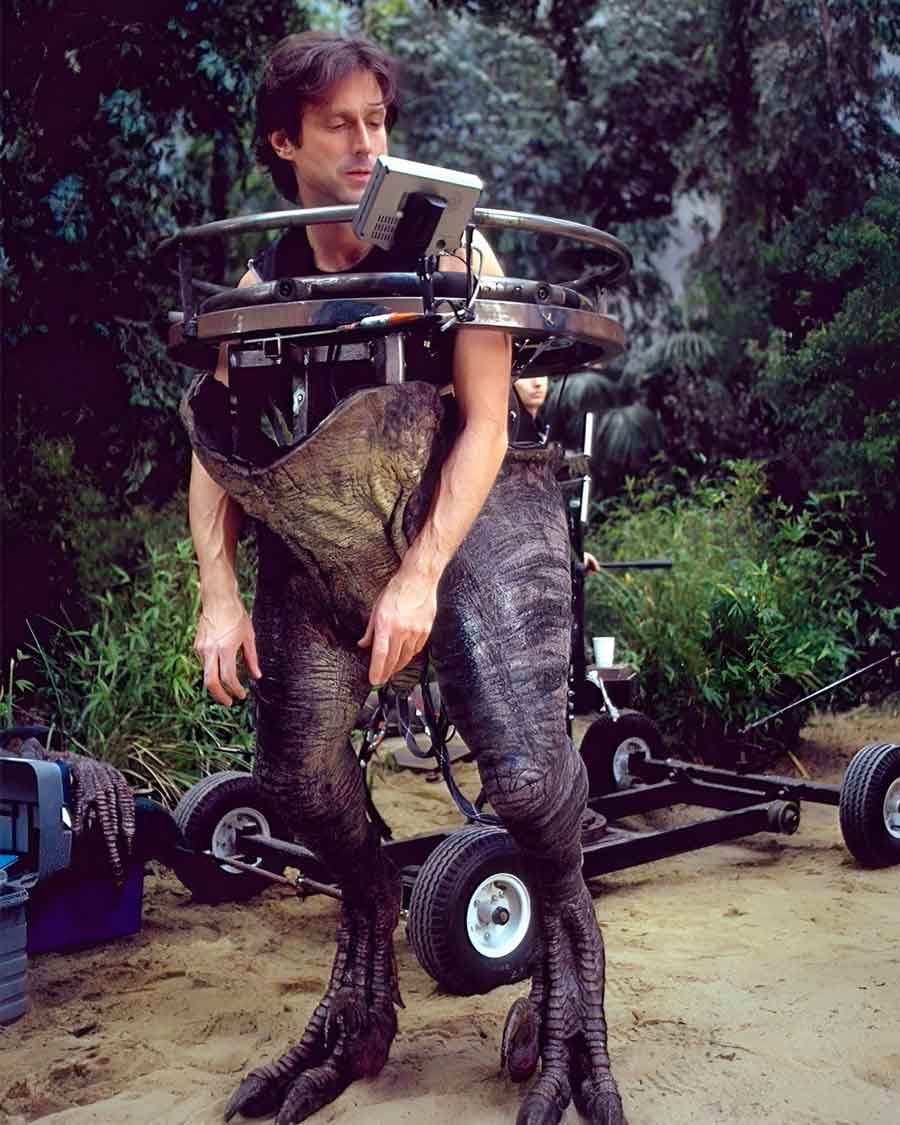 A stunt coordinator wears the animatronic dinosaur suit as he tries to replicate their walk on the sets. 