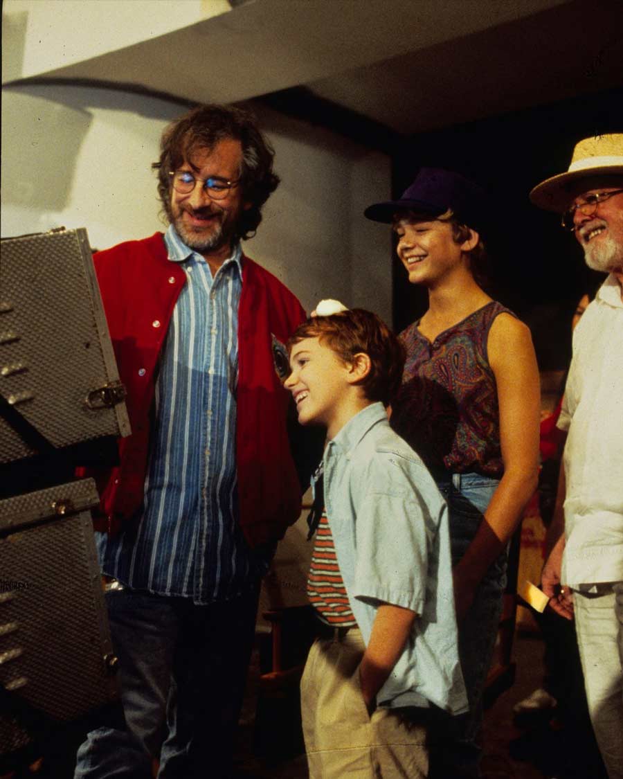 Steven Spielberg watching the monitor with Ariana Richards (Lex Murphy), Joseph Mazzello (Tim Murphy) and Richard Attenborough (Dr John Hammond). 