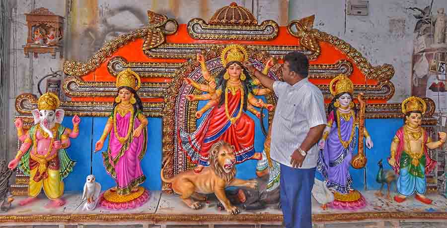 Artist Monti Paul gives finishing touches to a Durga idol on Tuesday. The idol will be ferried to New Jersey in the USA   