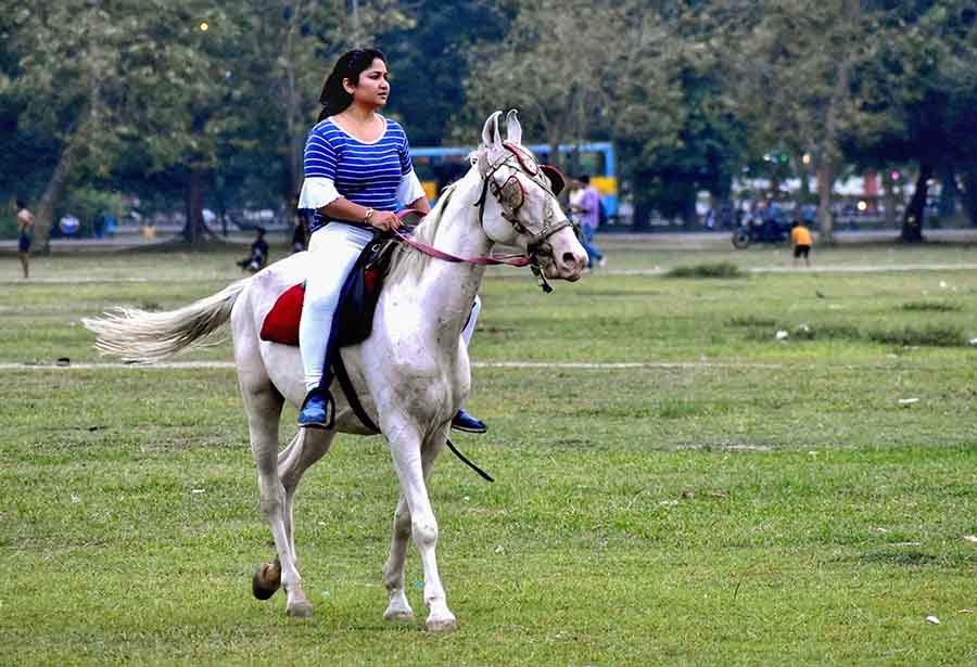 A girl enjoys a horse ride on the Maidan, Kolkata, on Wednesday  