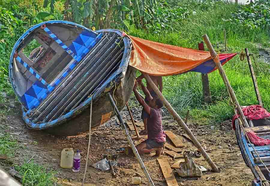 A boat being repaired before the onset of monsoon on the banks of river Hooghly  
