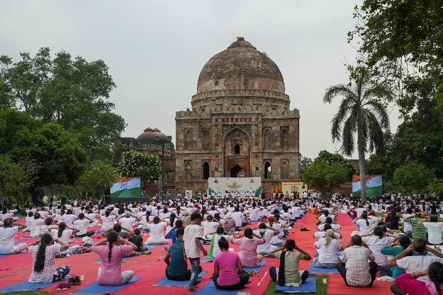 People perform yoga on the International Day of Yoga, at Lodhi Gardens in New Delhi. 