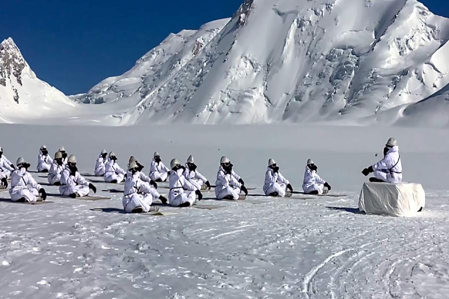 Army personnel perform yoga on the International Day of Yoga, at Siachen Glacier. 