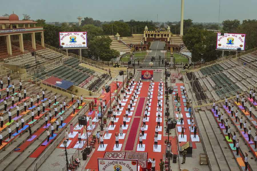 Border Security Force (BSF) personnel and others perform yoga during a session on the International Day of Yoga, at the Attari - Wagah border near Amritsar. 