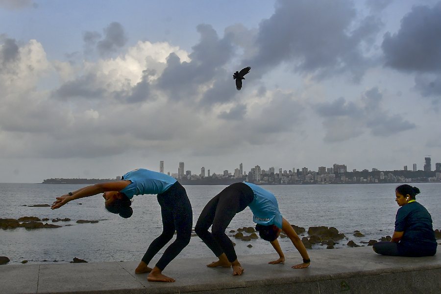 People perform yoga to celebrate the International Day of Yoga, at Marine Drive in Mumbai. 