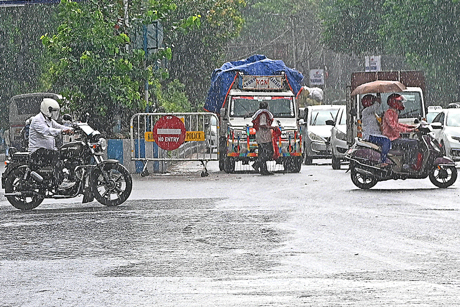 Commuters amid rain in Bhowanipore on Friday afternoon.