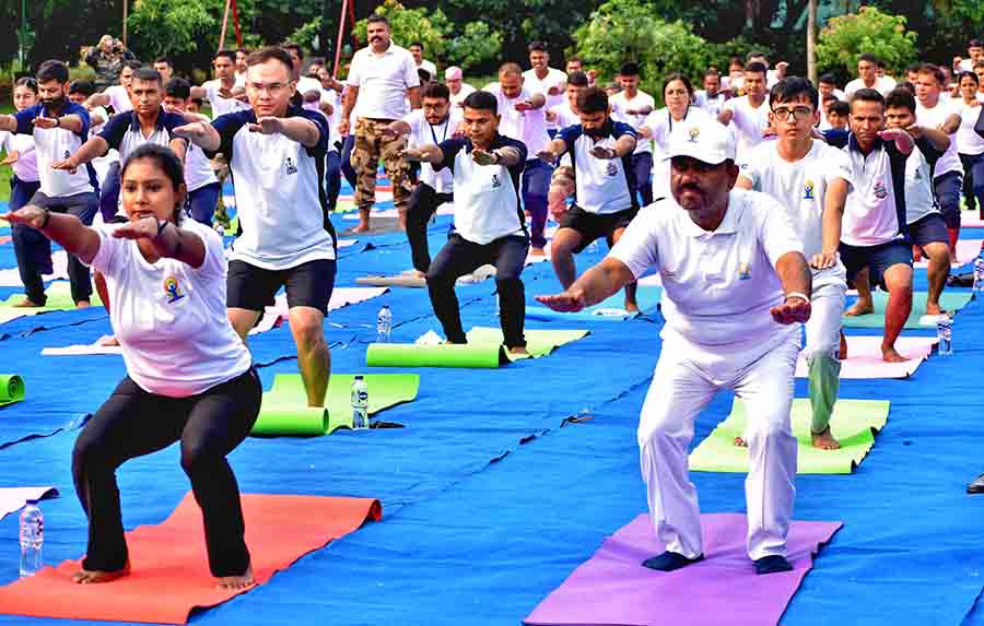 West Bengal governor C.V. Ananda Bose takes part in a yoga session on the lawns of Raj Bhavan on International Yoga Day on Wednesday  
