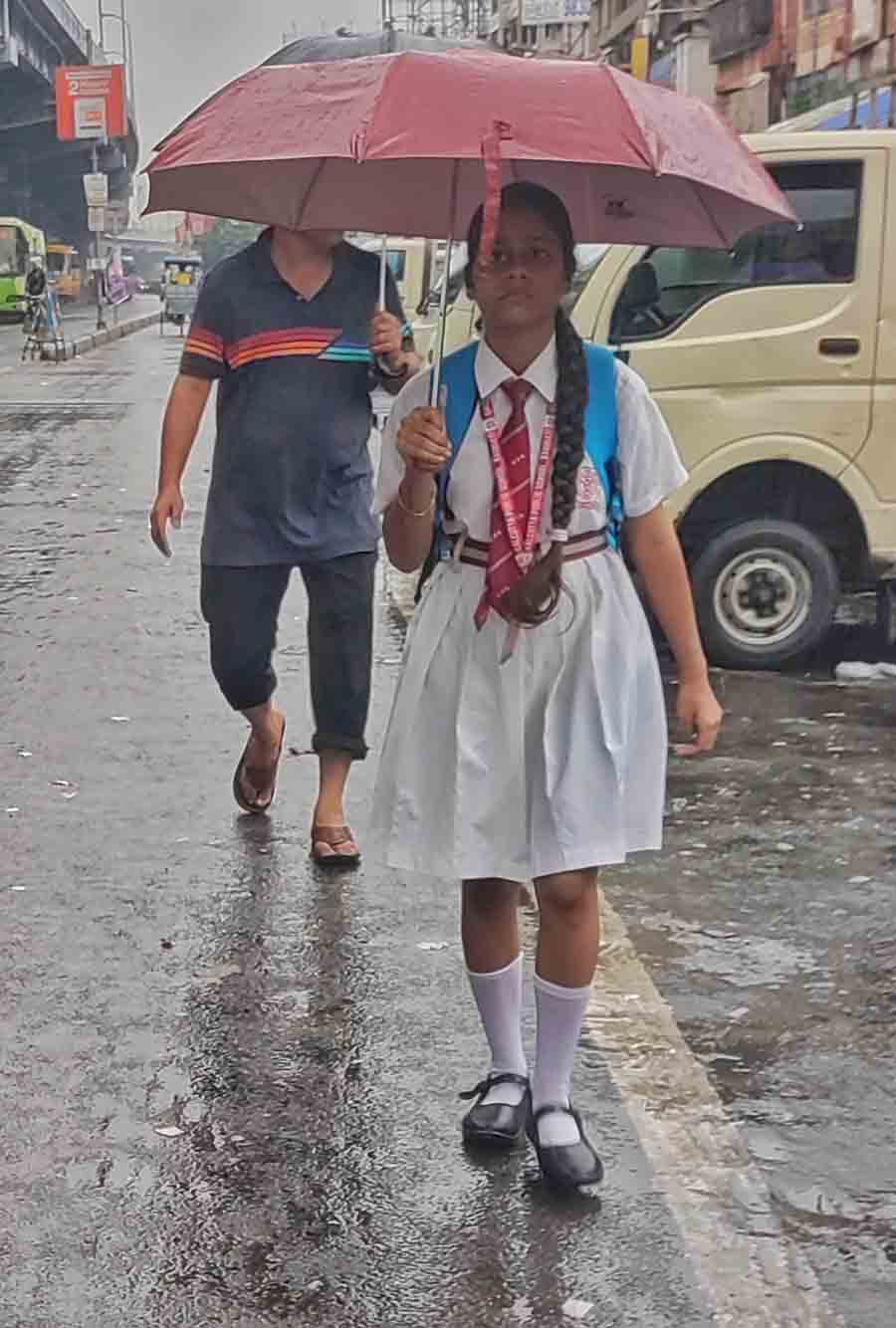 A school girl walks it down along VIP Road to her classes early on Wednesday morning 