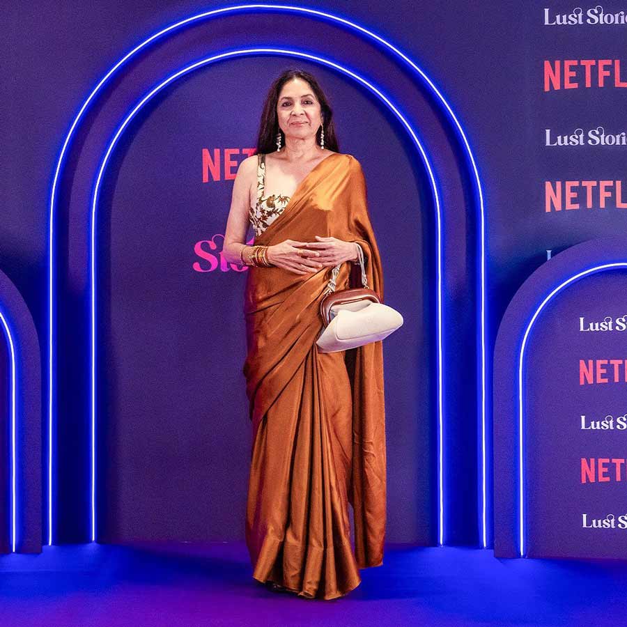 Neena Gupta looked stunning in a brown satin sari paired with a floral blouse. 