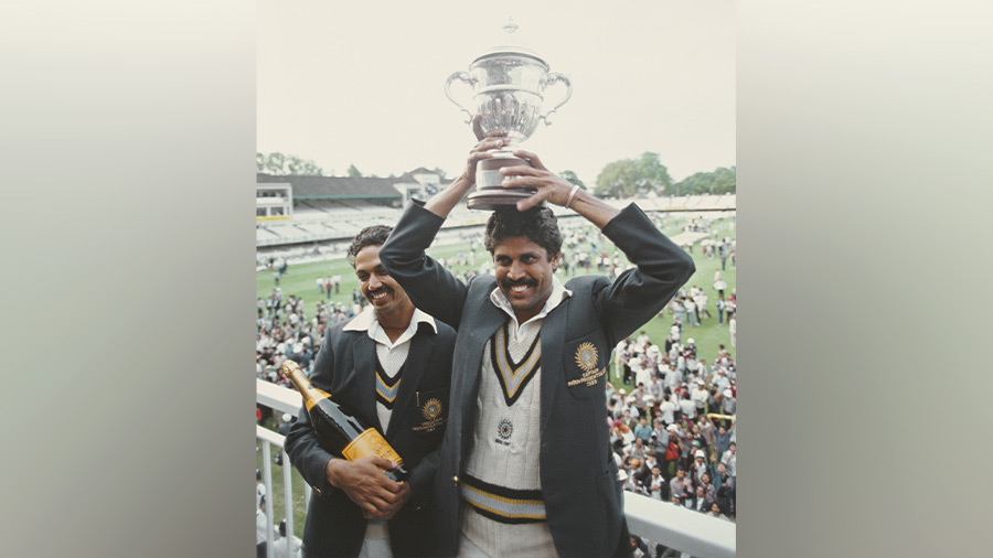 India players Kapil Dev (r) lifts the trophy as Man of the Match Mohinder Amarnath looks on after the 1983 Prudential World Cup Final victory against West Indies at Lords on June 25, 1983 
