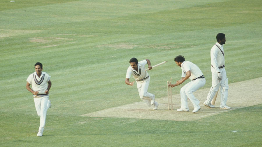 Victorious India players Yaspal Sharma and Roger Binny grab souvenir stumps as Mohinder Amarnath (l) runs off the field as West Indies batsman Michael Holding looks on after the 1983 Prudential World Cup Final victory against West Indies at Lords