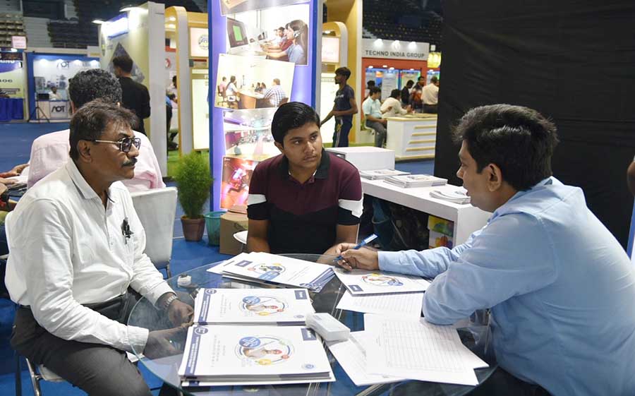 A college representative counsels an aspirant in the presence of his guardian at the APAI Pre Counselling Fair at Netaji Indoor Stadium on Friday. The fair will be held till July 2 