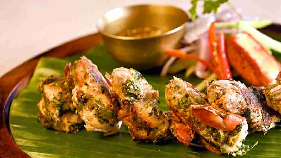 The prawns in Murshidabadi Tawa Chingri are marinated in grilled garden fresh spices and served with garlic chilli sauce. Rs599