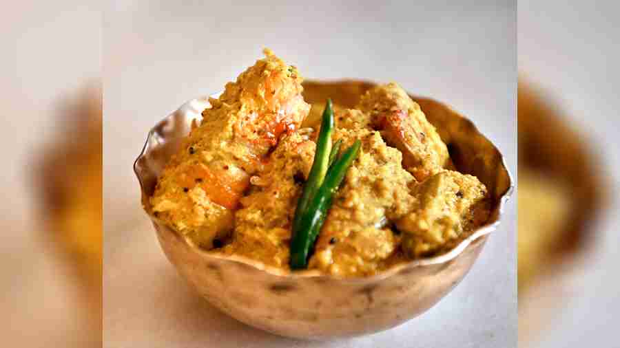 Kalo Jeere Narkol Chingri is made with prawns tempered with nigella seeds and finished with coconut and mustard. Rs 639