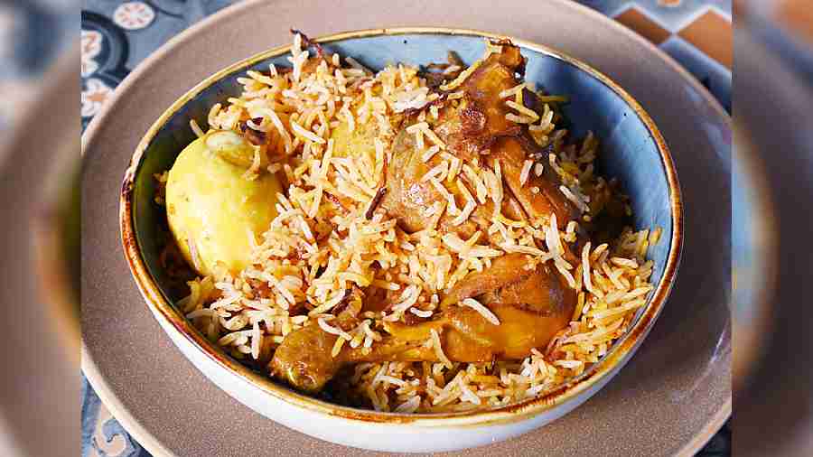 Murgh Biryani is the signature chicken biryani with a rich mix of basmati rice, potato and egg cooked delicately with aromatic spices on dum.