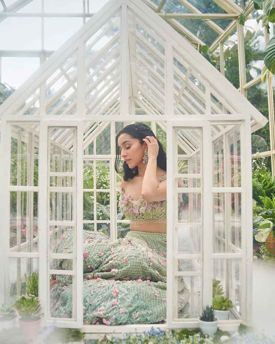 A green lehenga with pink roses all over it made for a straight-out-of-a-fairytale look for Shraddha, who paired the outfit with stunning earrings and pearls on her hair. 