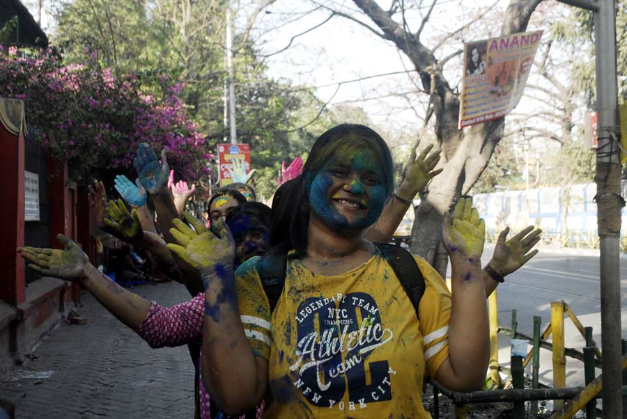 Students of Bethune College play with colours ahead of Holi on Friday March 3