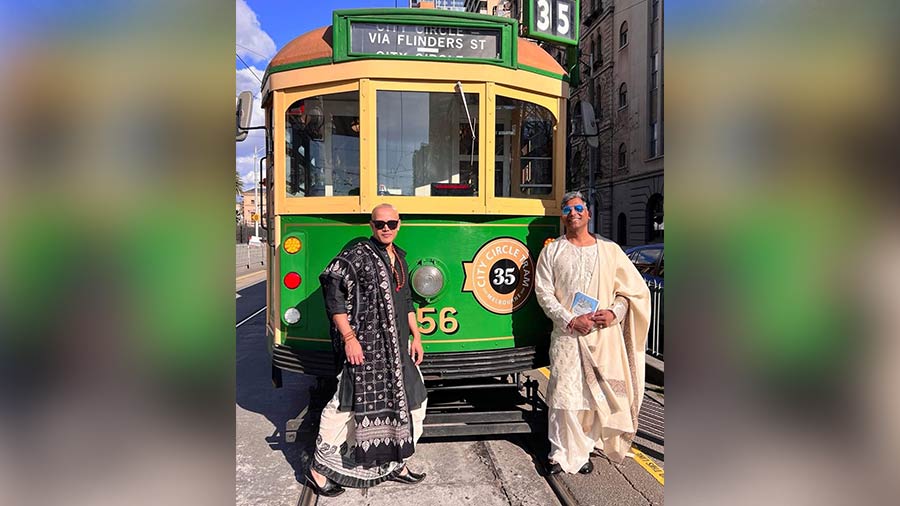 Indranil (right) poses with a friend in front of the 35 City Circle Tram, a free tram for tourists in Melbourne