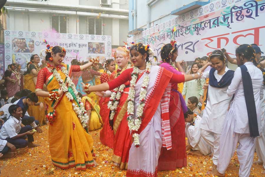 Visually impaired students take part in a Flower Holi celebration on Saturday. Sarodiya, a charitable trust, organised the event for the students of Light House for the Blind, Kolkata