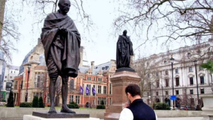 Rahul Gandhi pays tribute to the statue of Mahatma Gandhi in London on Sunday.