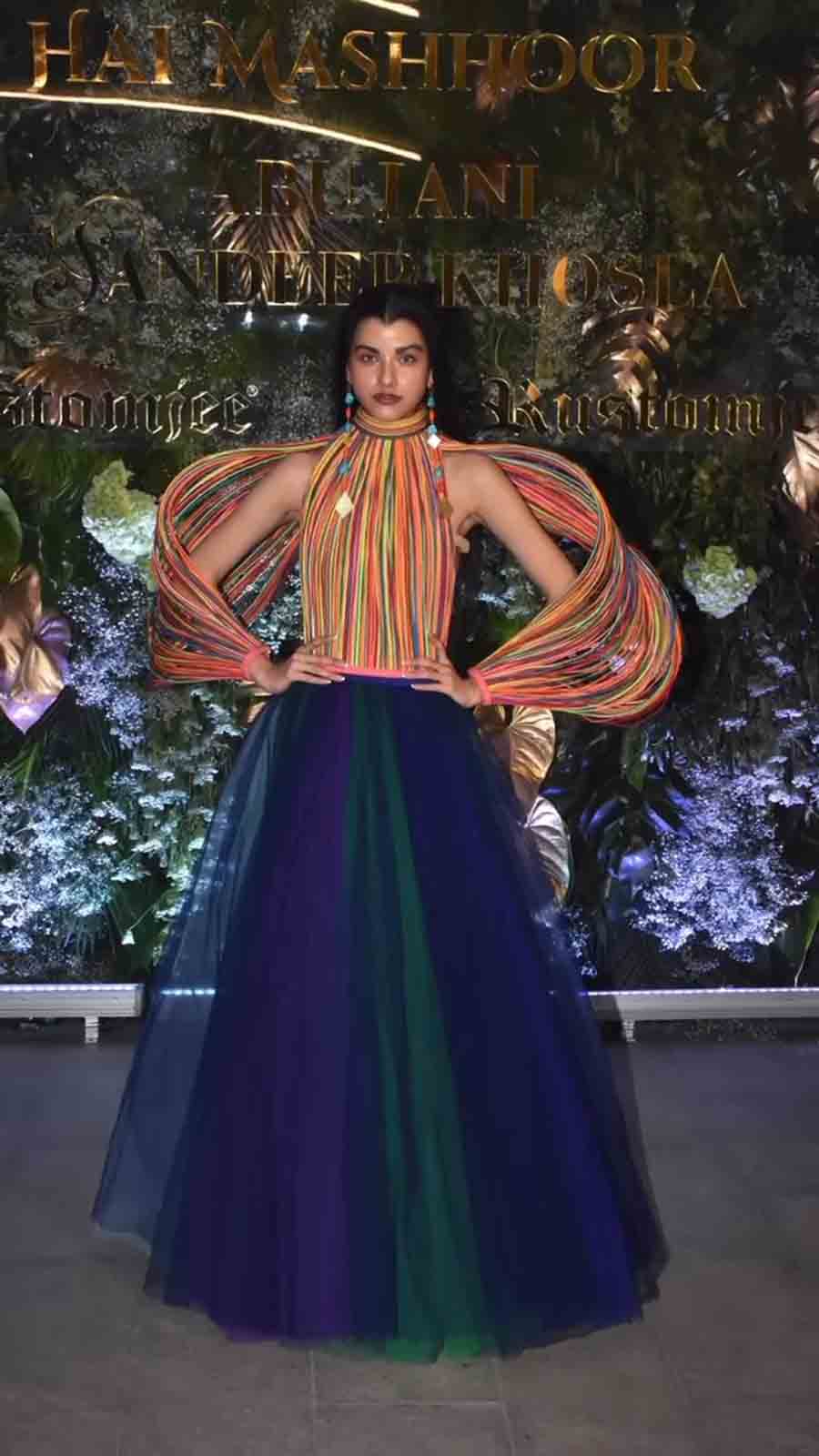 Ayesha Kanga wore a structured multicoloured top with a peacock organza skirt and tiered earrings. 