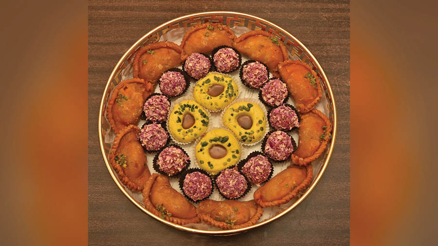 From outside to in — ‘gujiya’, Rose Laddoo and Thandai Bati