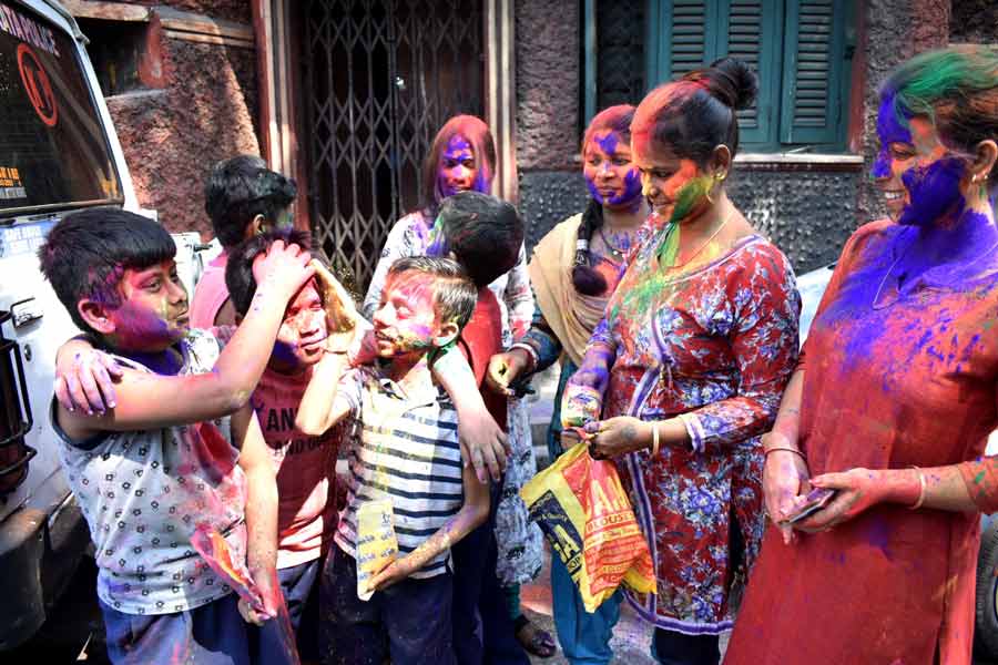 Students of A.V. School, north Kolkata, play Holi with their guardians