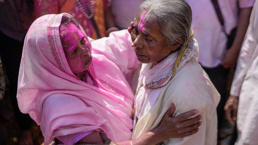 Widows and other devotees play with colours and flowers celebrating the festival of Holi, at Gopinath Temple in Vrindavan.