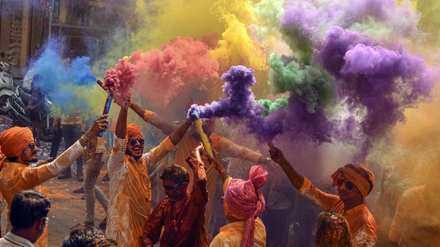 People play with colours to celebrate the festival of Holi, in Hyderabad.