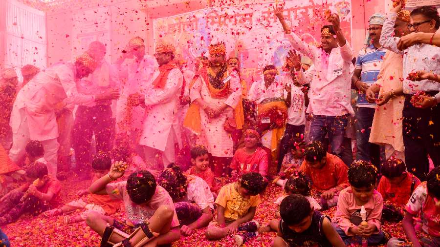 Children suffering from cerebral palsy play with colours during Holi celebrations, in Prayagraj.
