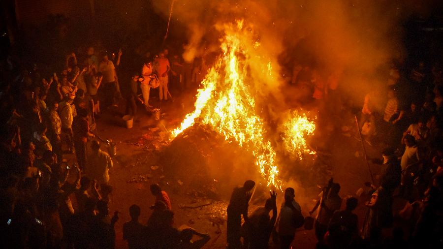 People take part in a Holika Dahan programme in Patna.